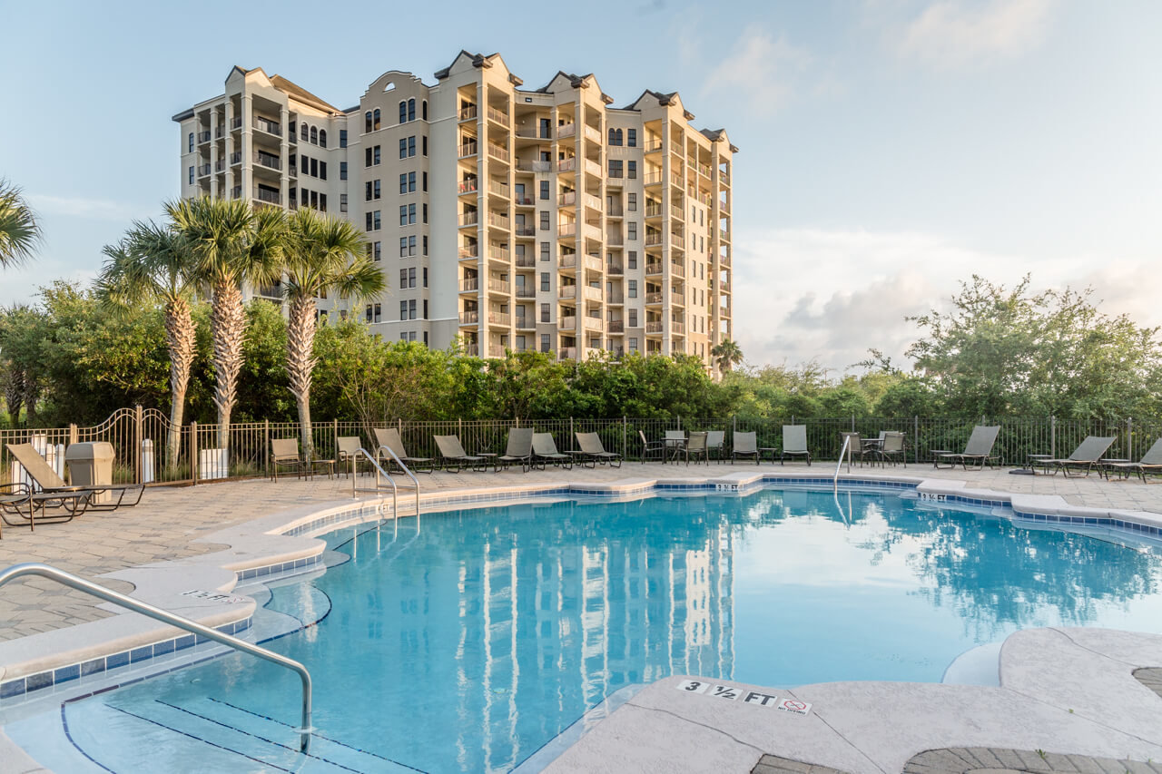 Beautiful lush tropical landscape surrounding the outdoor pool at Florencia condos in Perdido Key